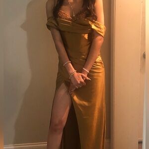 Fitted bronze ball gown with side slit.